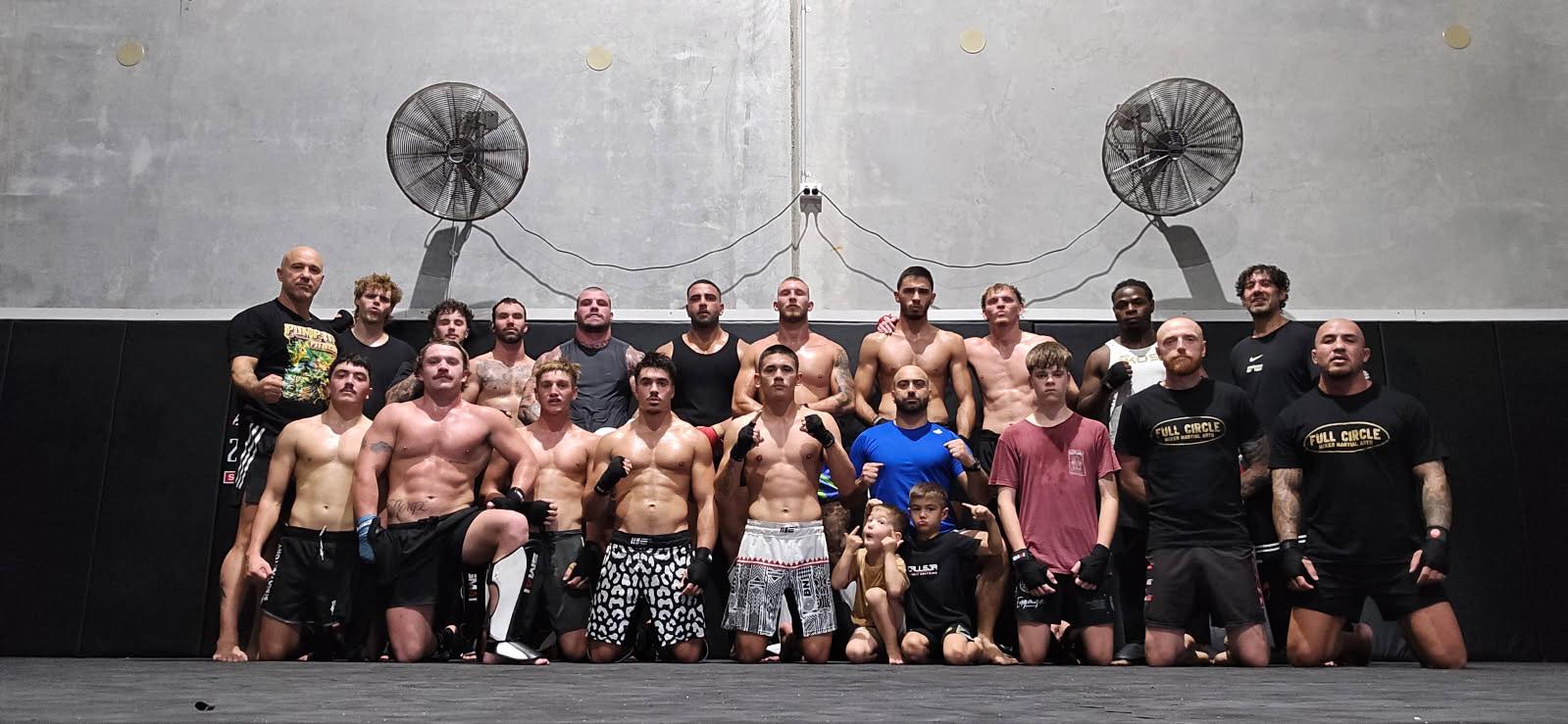 Fight team — post-session on the mat.