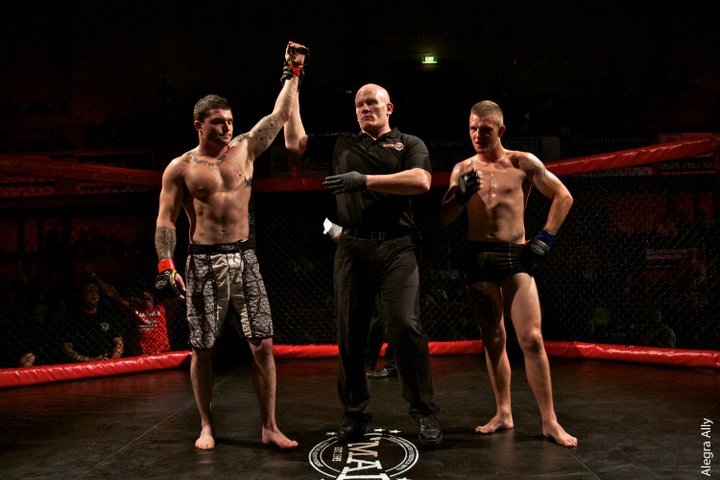 UFN title — Full Circle fighter with coaches cornering the belt.